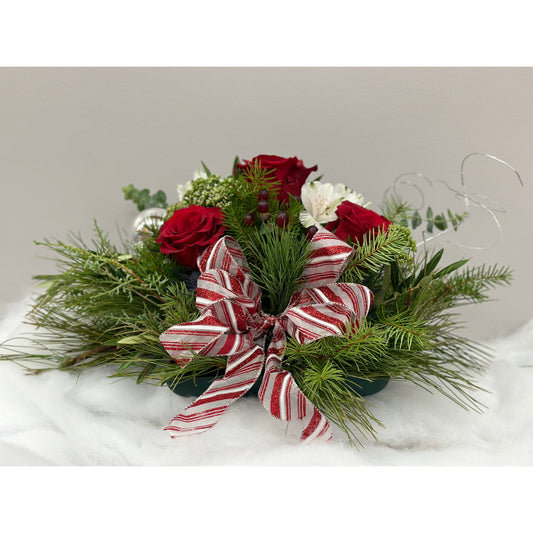 Elegant flower arrangement, created as a low centrepiece for your table.  Red roses with white accents and a red and white bow